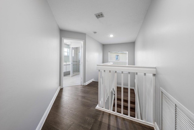 2261 Balsan Way, Wellington, FL 33414 - hall with an upstairs landing, hardwood / wood-style flooring, baseboards, and a textured ceiling