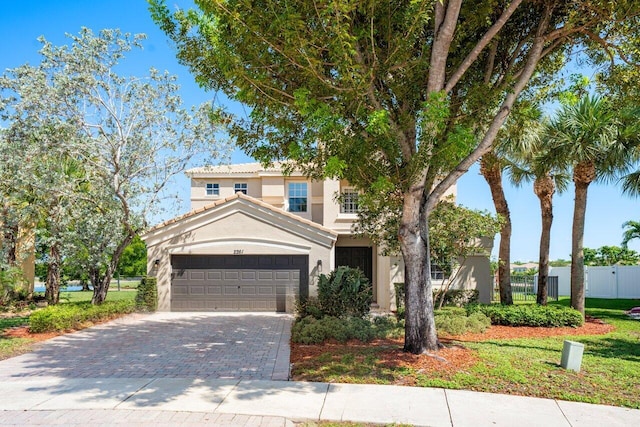 2261 Balsan Way, Wellington, FL 33414 - mediterranean / spanish house with stucco siding, decorative driveway, an attached garage, and a tiled roof