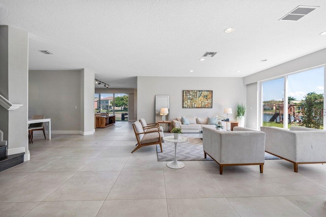 2261 Balsan Way, Wellington, FL 33414 - living area with healthy amount of natural light, recessed lighting, a textured ceiling, baseboards, and light tile patterned floors