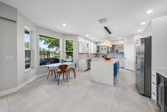 2261 Balsan Way, Wellington, FL 33414 - kitchen with stainless steel appliances, open shelves, light countertops, a center island, and recessed lighting