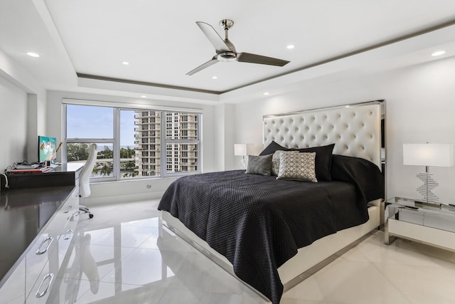 bedroom with a raised ceiling, light tile patterned flooring, and recessed lighting