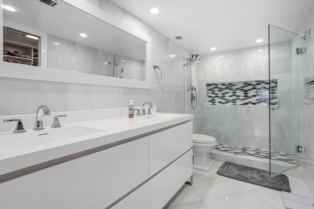 full bath featuring recessed lighting, double vanity, a stall shower, and a sink