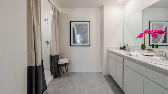 bathroom with a shower with curtain, a sink, and double vanity