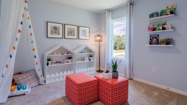 rec room featuring carpet and baseboards