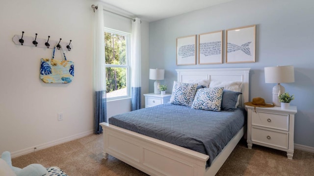 bedroom featuring baseboards, carpet floors, and multiple windows