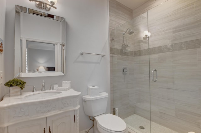 bathroom featuring vanity, toilet, and a stall shower