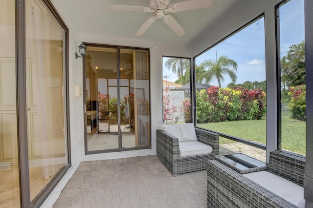 sunroom / solarium featuring plenty of natural light and ceiling fan