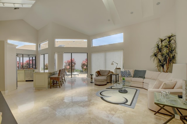living area with a wealth of natural light and high vaulted ceiling