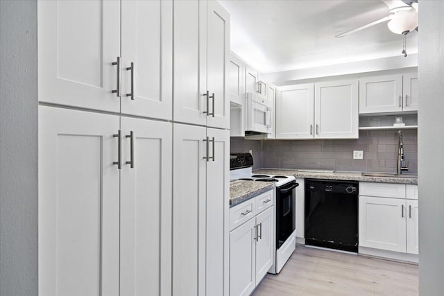 1521 NW 19th Ter Unit 101, Delray Beach, FL 33445 - kitchen with black dishwasher, range with electric cooktop, white microwave, a sink, and decorative backsplash