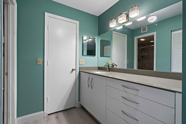 1521 NW 19th Ter Unit 101, Delray Beach, FL 33445 - bathroom featuring a stall shower, vanity, and wood finished floors