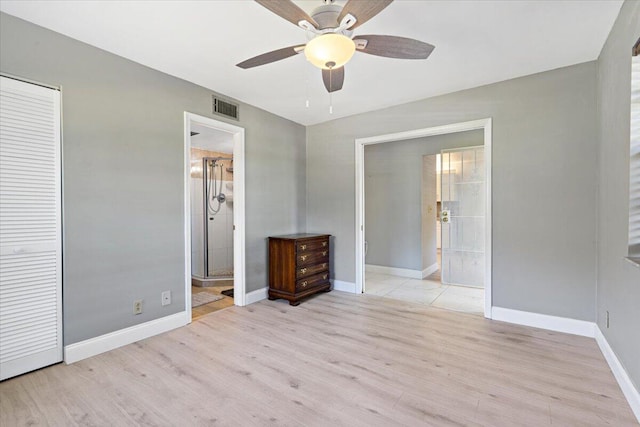 1521 NW 19th Ter Unit 101, Delray Beach, FL 33445 - unfurnished bedroom with light wood-style flooring, baseboards, ceiling fan, and a closet