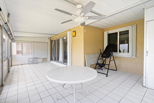 1521 NW 19th Ter Unit 101, Delray Beach, FL 33445 - sunroom featuring ceiling fan, a textured wall, and tile patterned floors