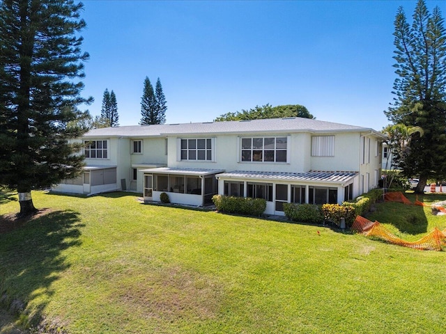 1521 NW 19th Ter Unit 101, Delray Beach, FL 33445 - view of front of house featuring a sunroom, stucco siding, and a front yard