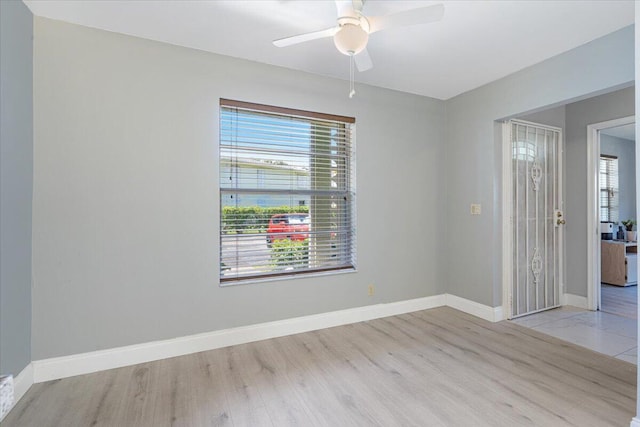 1521 NW 19th Ter Unit 101, Delray Beach, FL 33445 - spare room with wood finished floors, a ceiling fan, and baseboards