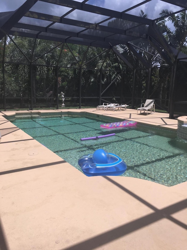 17768 Temple Blvd, Loxahatchee, FL 33470 - swimming pool featuring a patio and glass enclosure