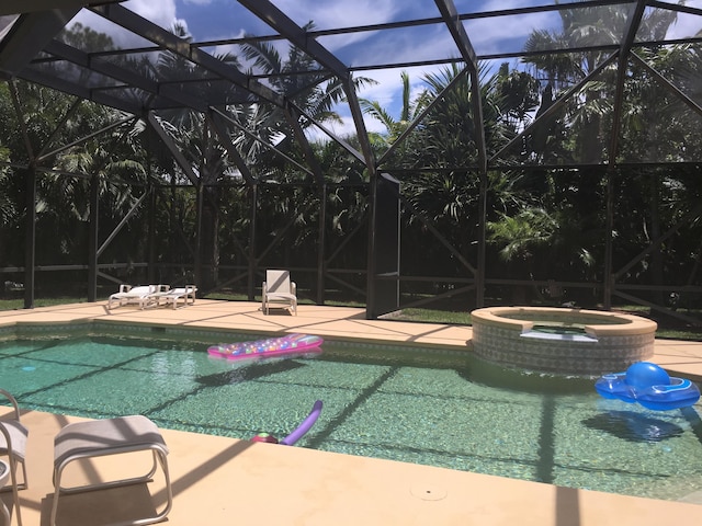 17768 Temple Blvd, Loxahatchee, FL 33470 - view of pool with glass enclosure, a patio, and a pool with connected hot tub