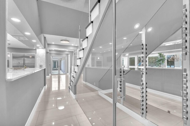 interior space featuring recessed lighting, tile patterned floors, baseboards, and french doors