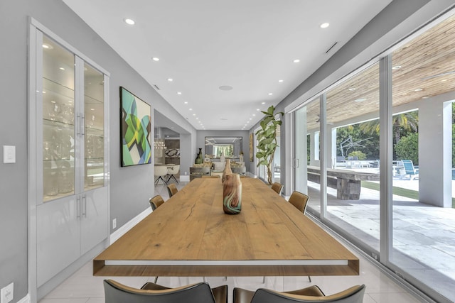 dining space featuring light tile patterned floors and recessed lighting