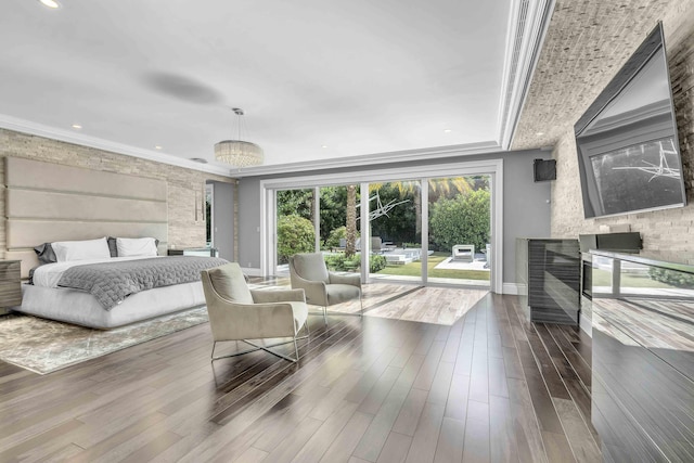 bedroom featuring a fireplace, dark wood finished floors, baseboards, access to exterior, and recessed lighting