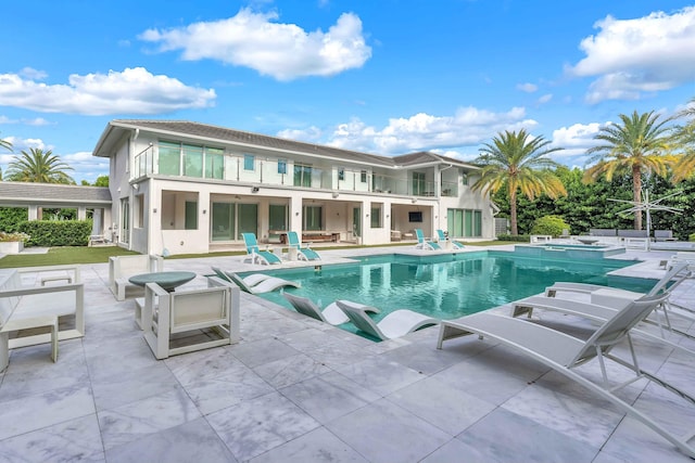 view of pool featuring a pool with connected hot tub and a patio