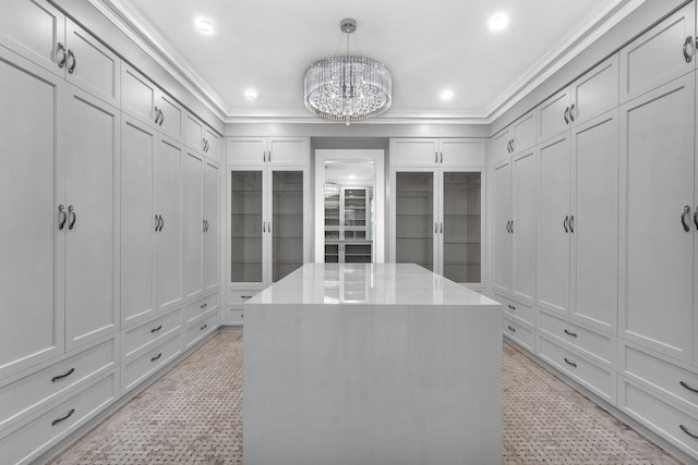 walk in closet featuring light floors and an inviting chandelier