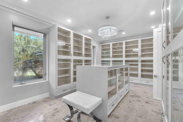 spacious closet with a chandelier