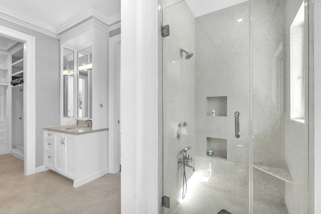 bathroom with vanity, crown molding, a stall shower, and tile patterned floors
