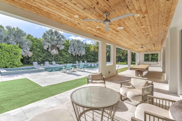 view of patio featuring an outdoor pool and ceiling fan