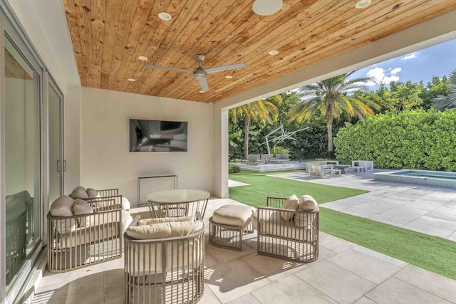 view of patio featuring an outdoor hangout area, a ceiling fan, and an in ground hot tub