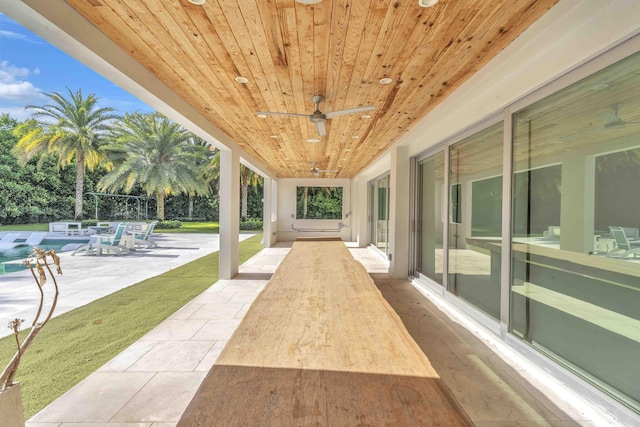 view of patio / terrace featuring ceiling fan and an outdoor pool