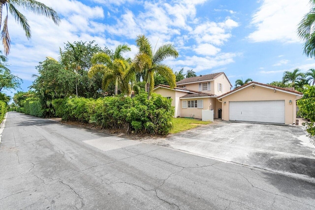 255 Russlyn Dr, West Palm Beach, FL 33405 - view of front of property featuring a garage, driveway, and stucco siding