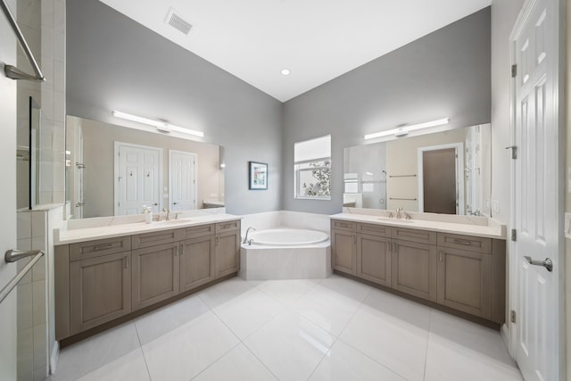 full bath featuring a garden tub, a sink, and a shower stall