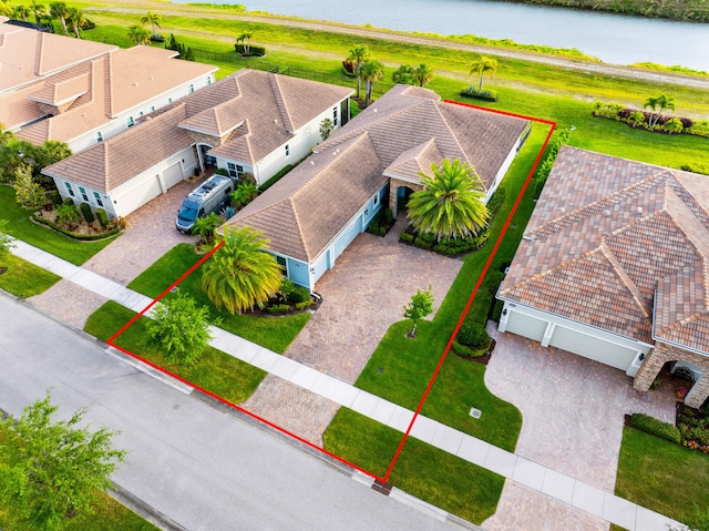 birds eye view of property with a water view