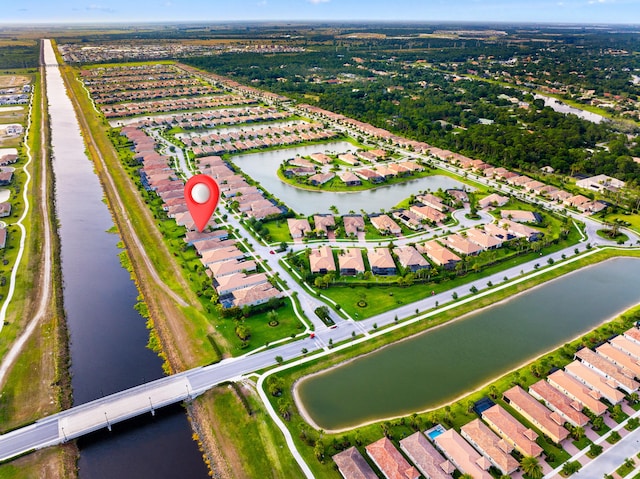 birds eye view of property with a water view and a residential view