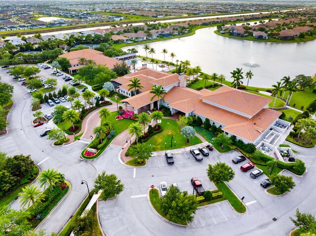 drone / aerial view with a residential view and a water view