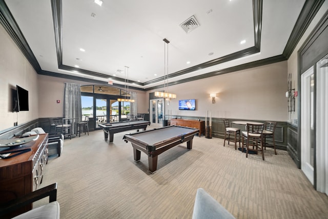 playroom with light colored carpet, a decorative wall, crown molding, and a tray ceiling