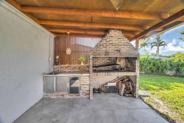 view of patio / terrace featuring a sink and a fireplace