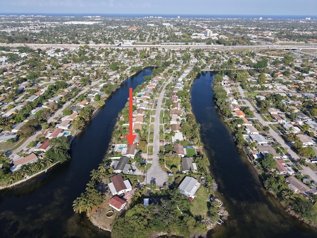 drone / aerial view with a water view and a residential view