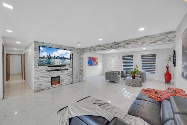 living area featuring marble finish floor, recessed lighting, visible vents, and a fireplace