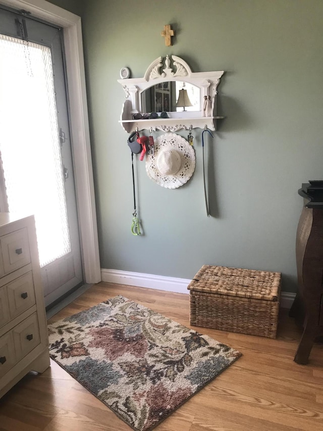 mudroom featuring baseboards and wood finished floors