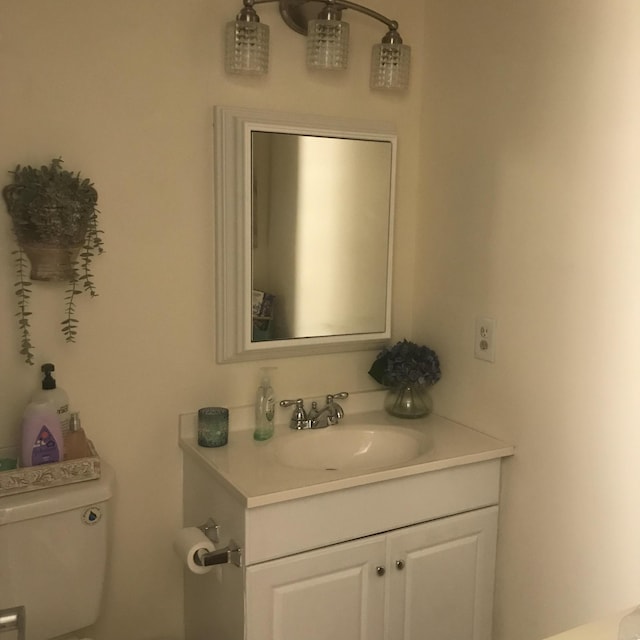 bathroom with toilet and vanity