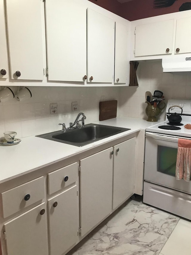kitchen with white electric range oven, under cabinet range hood, a sink, light marble finish floors, and light countertops