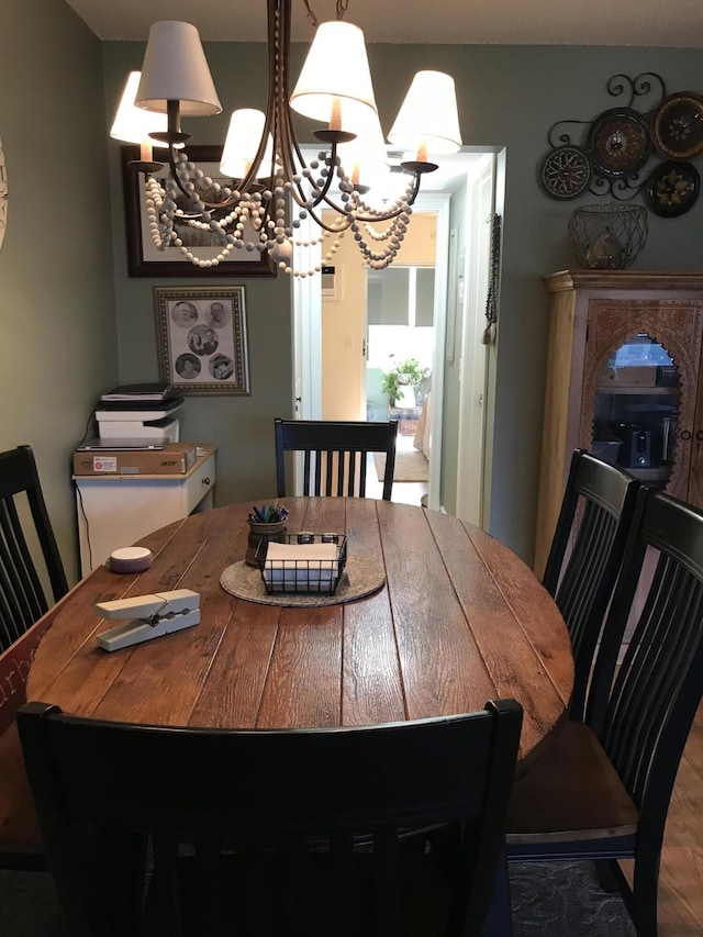 dining space featuring a chandelier and wood finished floors