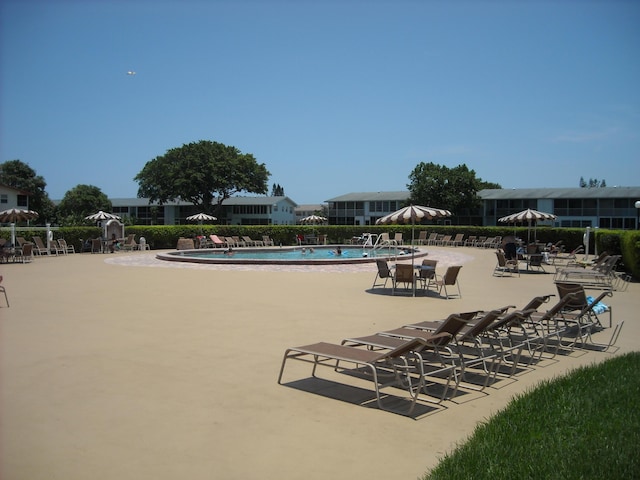 community pool featuring a patio area and fence