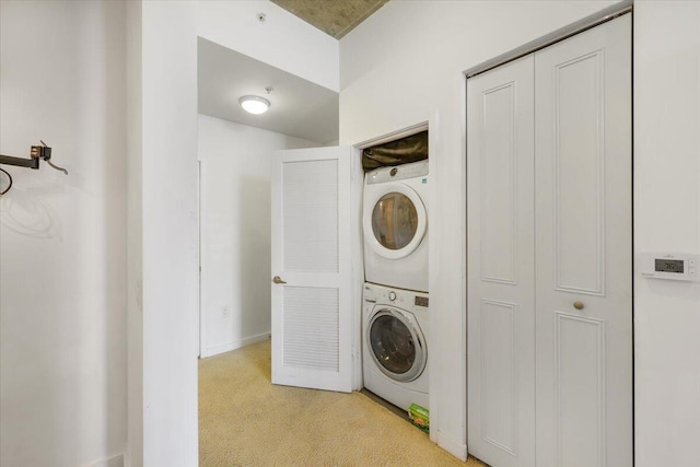 300 S Australian Ave Unit 717, West Palm Beach, FL 33401 - laundry room featuring estacked washer and dryer and light colored carpet