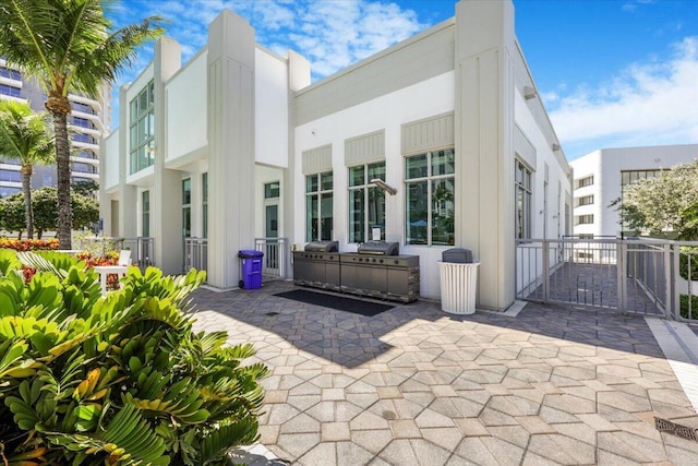 300 S Australian Ave Unit 717, West Palm Beach, FL 33401 - rear view of property featuring a patio area, a chimney, and exterior kitchen