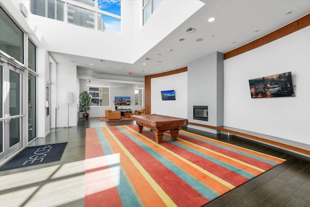 300 S Australian Ave Unit 717, West Palm Beach, FL 33401 - playroom featuring wood finished floors, pool table, a high ceiling, recessed lighting, and a fireplace