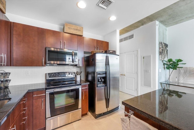 300 S Australian Ave Unit 717, West Palm Beach, FL 33401 - kitchen with appliances with stainless steel finishes, decorative backsplash, dark stone counters, recessed lighting, and light tile patterned floors