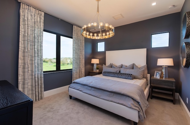 carpeted bedroom with baseboards and a notable chandelier