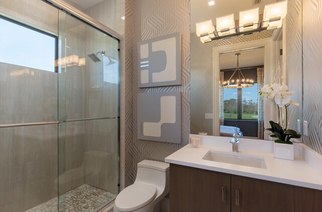 ensuite bathroom featuring wallpapered walls, a shower stall, and ensuite bathroom